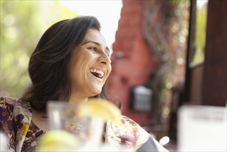 Smiling Hispanic woman in restaurant