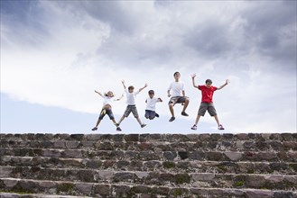 Children jumping on top of steps