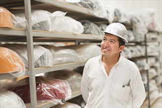 Worker smiling in manufacturing plant