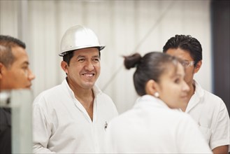 Worker smiling in manufacturing plant