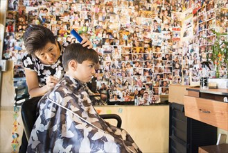 Boy having hair cut in salon