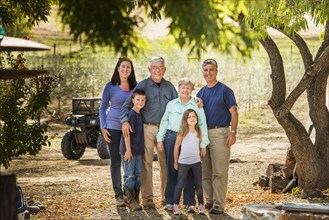 Family smiling in olive grove