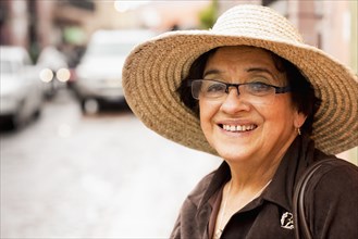Older Hispanic woman wearing sunhat