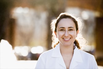 Hispanic doctor smiling outdoors