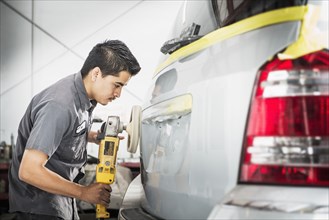Hispanic mechanic working in auto shop