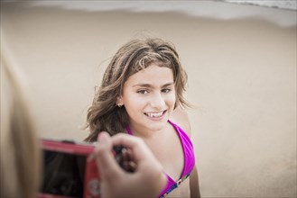 Girl posing for photograph on beach