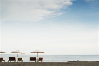 Silhouette of tables and chairs on beach