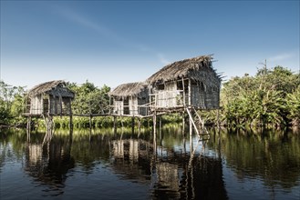 Thatch houses built over rural lake