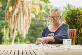 Caucasian woman playing cards outdoors