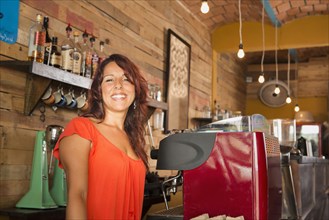 Hispanic woman working in coffee shop