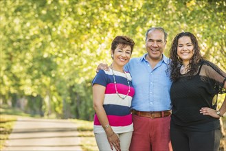 Hispanic family smiling together outdoors