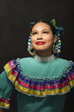 Hispanic teenage girl wearing Puebla Folkloric dress