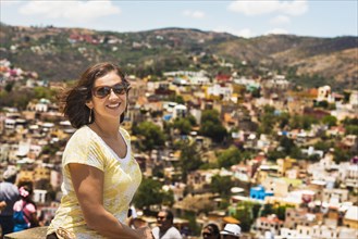 Hispanic woman standing on scenic rooftop