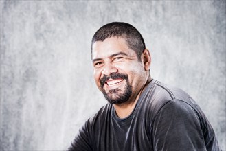 Close up of smiling Hispanic man