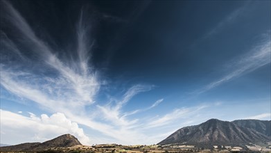 Cloudy blue sky over mountains in remote landscape