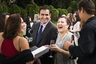 Hispanic family laughing at wedding
