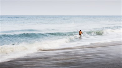 Man swimming in waves