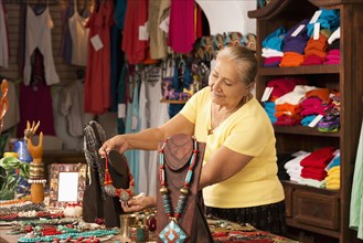 Smiling woman working in traditional gift shop