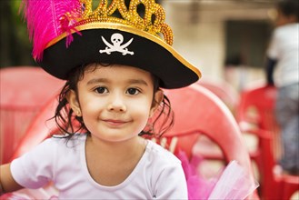 Hispanic girl wearing pirate hat at party