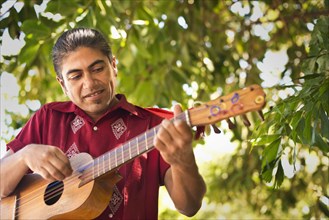Hispanic musician performing in park