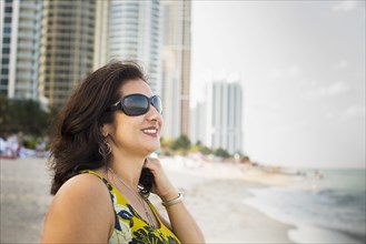 Hispanic woman standing on urban beach