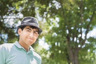 Hispanic teenage boy smiling outdoors