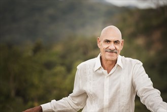 Hispanic man smiling outdoors