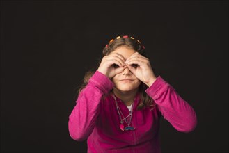 Mixed Race girl gesturing binoculars