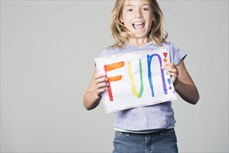 Happy Mixed Race girl holding fun sign
