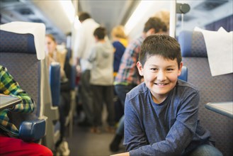 Hispanic boy smiling on train
