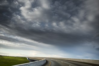 Clouds over winding highway