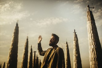 Caucasian man praying near spires
