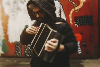 Caucasian man playing accordion