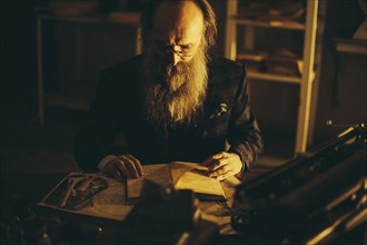 Caucasian man with beard reading book