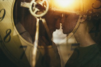 Double exposure of clock and Caucasian couple