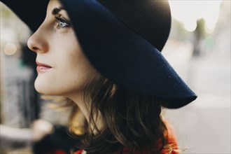 Profile of Caucasian woman wearing hat