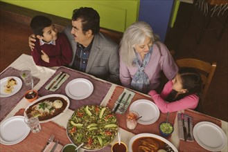 High angle view of grandparents and grandchildren in restaurant