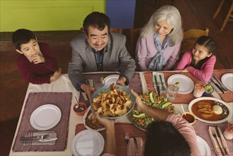 High angle view of family enjoying dinner in restaurant