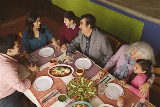 High angle view of family enjoying dinner in restaurant