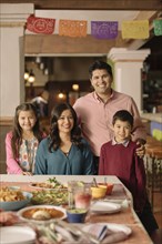 Portrait of smiling Hispanic family in restaurant