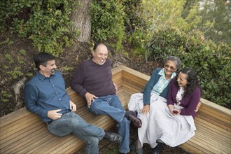 People sitting on bench and laughing