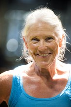 Portrait of smiling older woman sweating