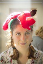 Smiling Caucasian girl wearing Christmas decoration on head
