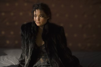 Serious Hispanic woman in fur coat