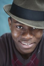 Smiling mixed race man in fedora