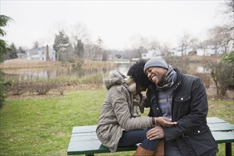 Couple laughing together in park