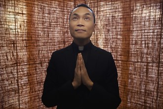 Pacific Islander priest praying
