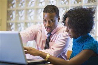African American businessman working with female co-worker