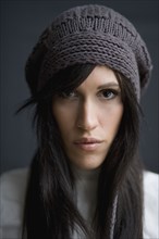 Serious mixed race woman wearing knit cap