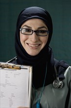 Middle Eastern doctor holding medical chart